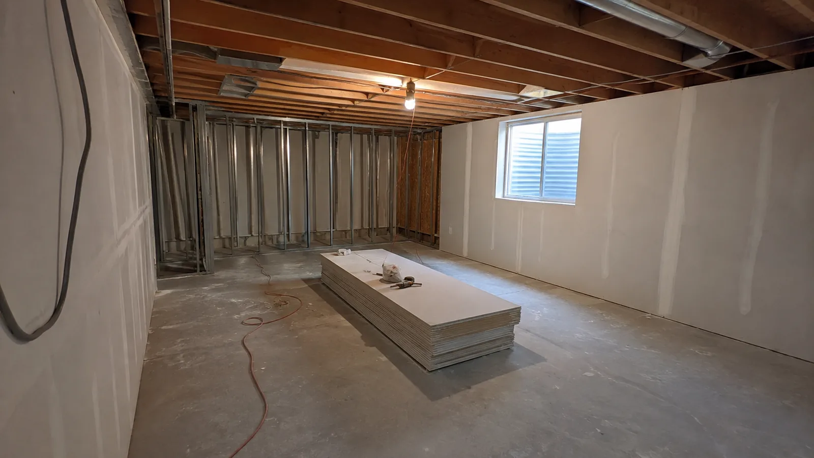 Unfinished Arvada, CO basement partway through being drywalled, framing and ductwork exposed