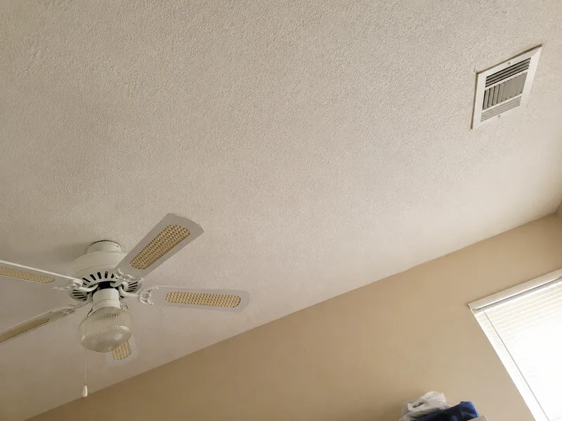 The same Arvada, CO ceiling after drywall repair, re-textured and repainted with no visible patch