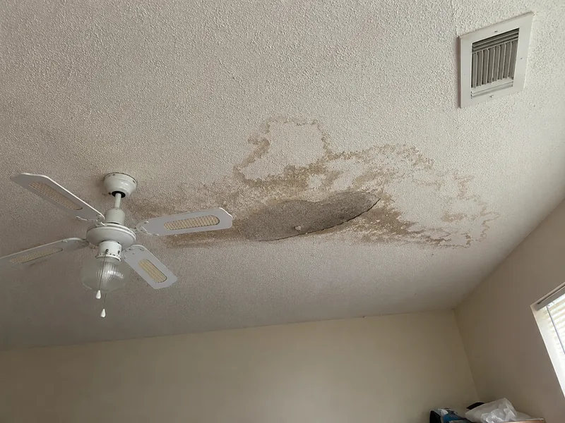 Water stained and sagging popcorn ceiling before repair in an Arvada, CO home