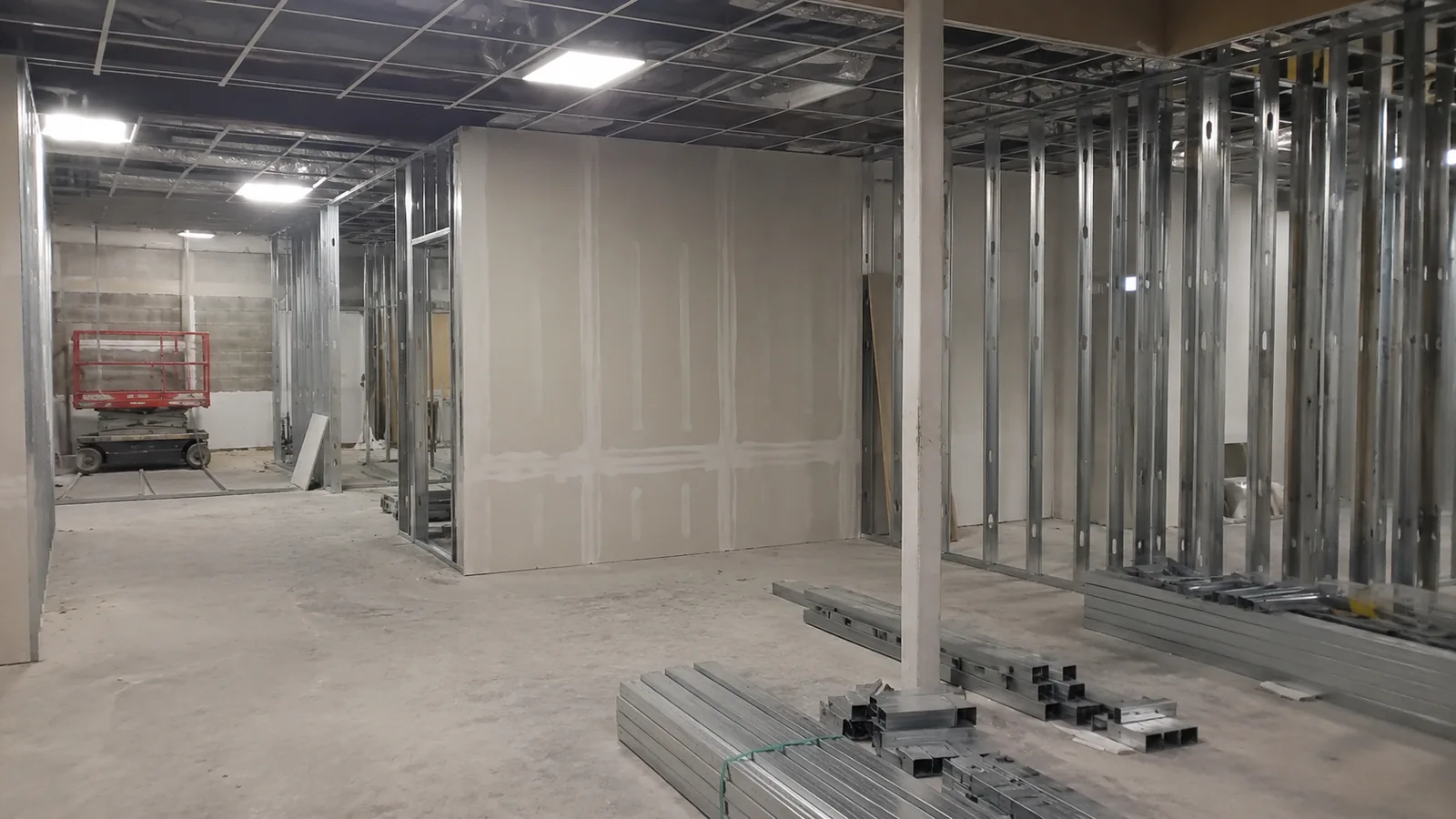 Steel stud partitions and gypsum board going up in a commercial tenant space in Arvada, CO