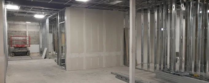 Steel stud partitions and gypsum board going up in a commercial tenant space in Arvada, CO