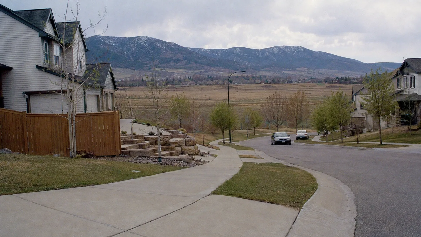 1990s houses backing onto open grassland with the foothills behind in Superior, CO
