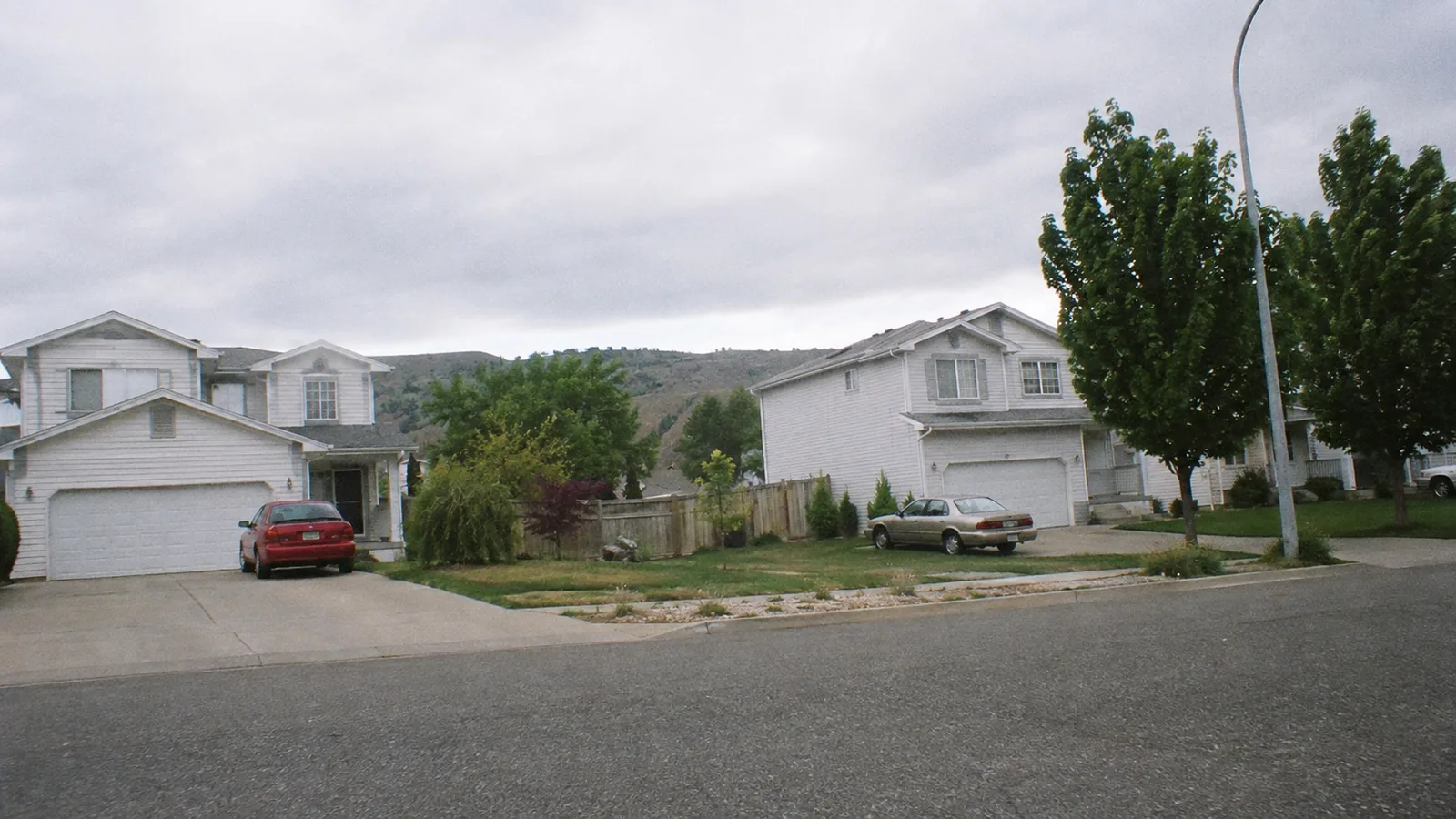 1990s two storey houses on a flat wide street in Thornton, CO